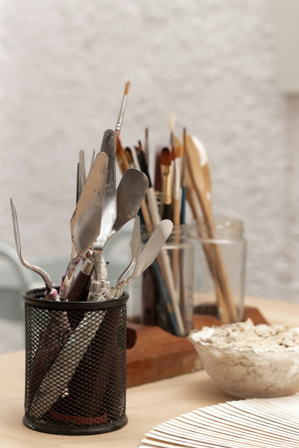 Art and craft supplies on a wooden table.